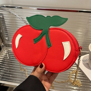 Cute red cherry shaped crossbody bag with green leaf detail and gold chain strap