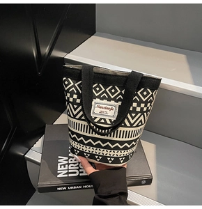 Detail of canvas bucket bag featuring geometric ethnic prints and Nanxiaojie logo label