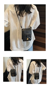 Detail view of black quilted leather crossbody phone bag with gold charm on stair backdrop