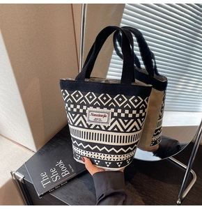 Detail of canvas bucket bag showing ethnic geometric print and Nanxiaojie brand label