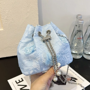 Light blue floral lace bucket bag with 3D butterfly decor and silver chain strap