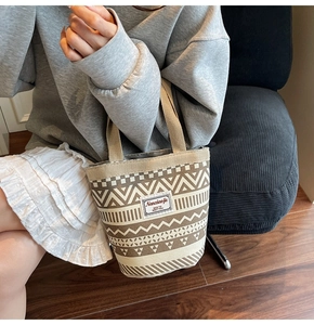 Detailed shot of large canvas tote bag with ethnic geometric patterns and top handles