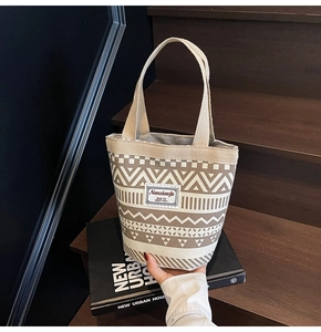 Close-up of geometric pattern canvas bucket bag with artistic tribal print and fabric tag