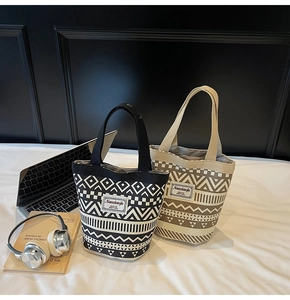 Detailed view of bohemian canvas bucket bags with geometric patterns and branded label