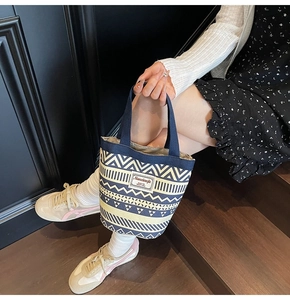 Detail of ethnic canvas bucket bag with geometric patterns and Nanxiaojie logo label