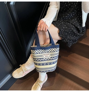 Close-up of geometric pattern on ethnic style canvas bucket bag with floral prints