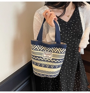 Detail of canvas bucket bag with ethnic geometric patterns and durable carry handle