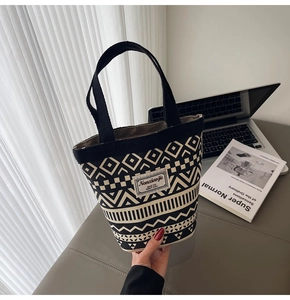 Detail of canvas bucket bag showing ethnic geometric prints and rectangular brand label