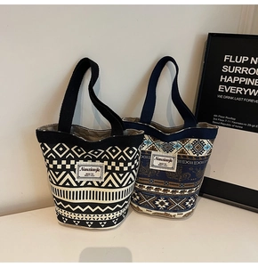 Detail of two retro canvas bucket bags with ethnic prints and geometric patterns