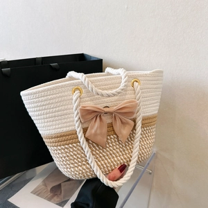 Handmade woven tote bag in white and beige with a large satin bow and cotton handles
