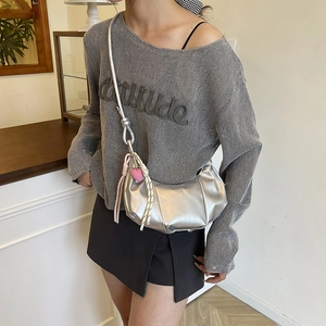 Silver metallic pleated crescent shoulder bag with heart pendant and adjustable strap