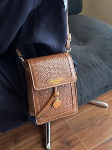 Brown woven texture leather crossbody phone bag with gold charm and adjustable strap