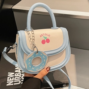 Cream and blue color-block saddle bag with cherry print and donut charm decoration