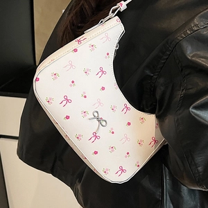 White hobo bag with pink bow and floral prints featuring a silver metal bow buckle