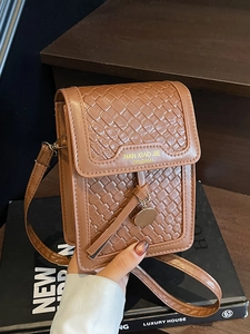 Brown woven crossbody phone bag with gold charm and adjustable shoulder strap for women