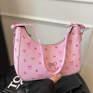Pink floral underarm bag with bow print and silver metal bow ornament detail
