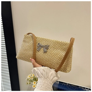Detail of woven small square shoulder bag with silver bow buckle and brown leather straps