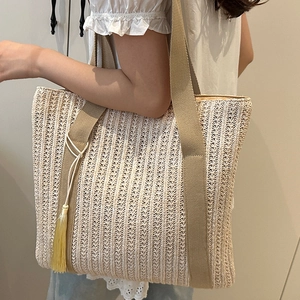 Large capacity woven straw shoulder bag with stylish tassel and wide straps for summer