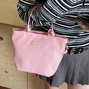 Pink waterproof nylon crossbody tote bag with Fashion label and fabric handles