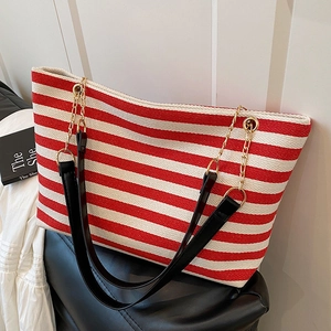 Red and white striped canvas tote bag with black leather straps and gold chain detail