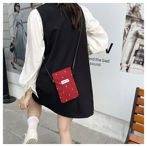 Detail of red floral mini canvas bucket bag for mobile phone with creative cat label