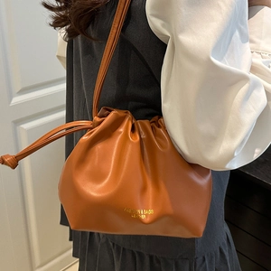 Fashionable caramel drawstring bucket bag with leather texture and thin shoulder strap