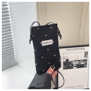 Detail of black pleated crossbody phone bag featuring white floral patterns and Creative Cat tag