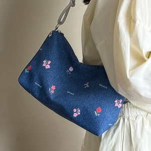 Blue denim hobo shoulder bag with pink floral embroidery and creative cat print
