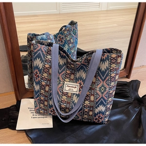 Detail view of ethnic weave tote bag with geometric patterns and dual handles