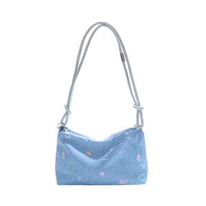 Light blue denim shoulder bag with floral print and adjustable rope strap on white background