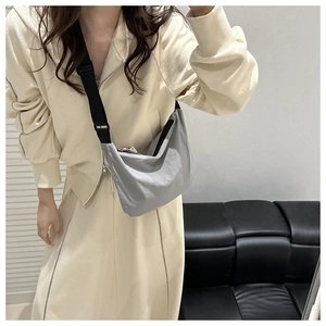 Gray waterproof fabric crossbody bag for women shown as a stylish shoulder bag on a model