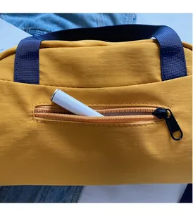 Detail of yellow nylon tote showing cross-grid texture and JL FASHION rubber logo