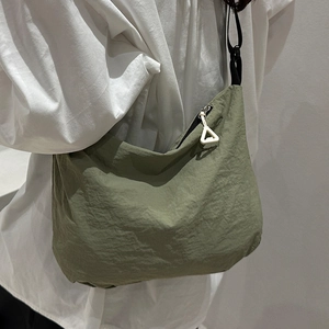 Minimalist military green waterproof nylon crossbody bag with adjustable strap