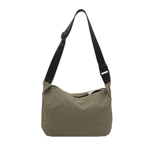 Olive green waterproof nylon crossbody bag with adjustable black strap for women