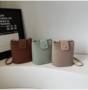 Three mini woven bucket bags in brown, mint green, and beige on a minimal white display