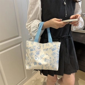 Grand sac fourre-tout en toile beige avec imprimés graffiti bleu et anses tissées