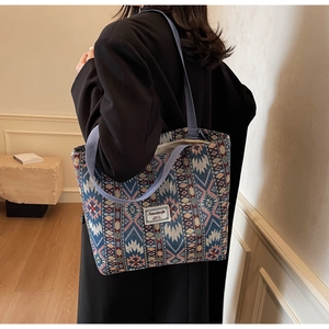 Close-up of ethnic tote bag with colorful geometric patterns and branded label detail