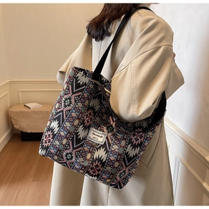 Ethnic style jacquard tote bag with geometric patterns and wide black shoulder strap