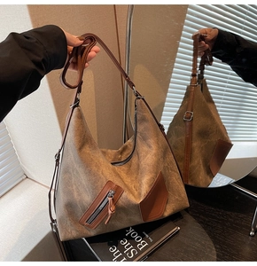 Detail of vintage brown canvas hobo bag showing retro texture and adjustable leather strap