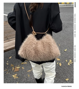 Detail of khaki faux fur bucket bag with knot shoulder strap on casual outfit