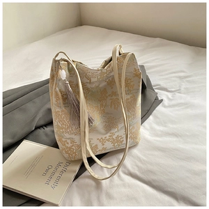 Detail of Chinese style embroidery tote bag with golden landscape patterns and silk tassel