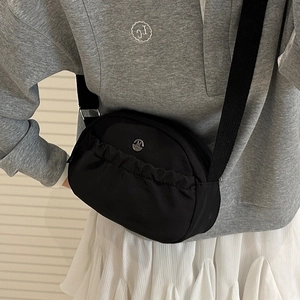 Borsa a tracolla minimalista in nylon nero con pieghe e logo in metallo per uso quotidiano