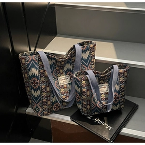Close-up of bohemian jacquard tote bags with ethnic geometric patterns on a modern step