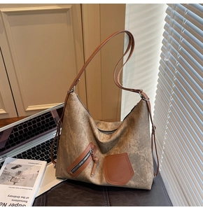Close-up of vintage brown tote bag with matte texture and stylish leather pocket details