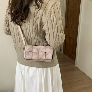 Beige woven leather square crossbody bag with wide strap for a minimalist autumn look