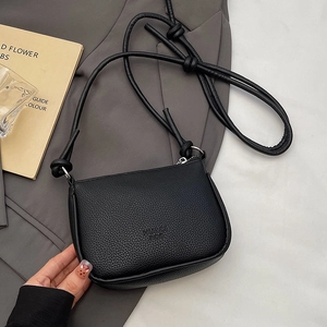 Minimalist black lychee pattern leather crossbody bag with decorative strap knot