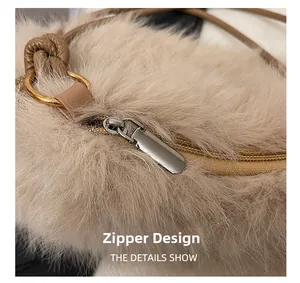 Detail of silver metal zipper and soft beige plush fabric on the bucket bag