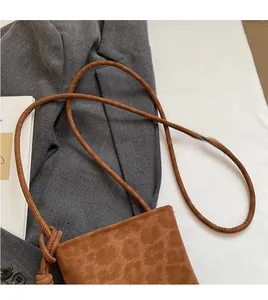 Detail of leopard print crossbody bag with comfortable round strap and knot design