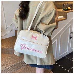 Close-up of pink bow embroidery on cream PU leather JK style shoulder tote bag