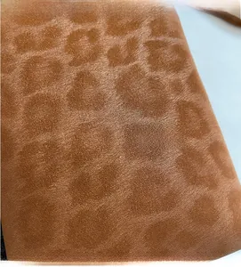 Close-up of leopard print fabric texture on a soft brown crossbody mobile phone bag